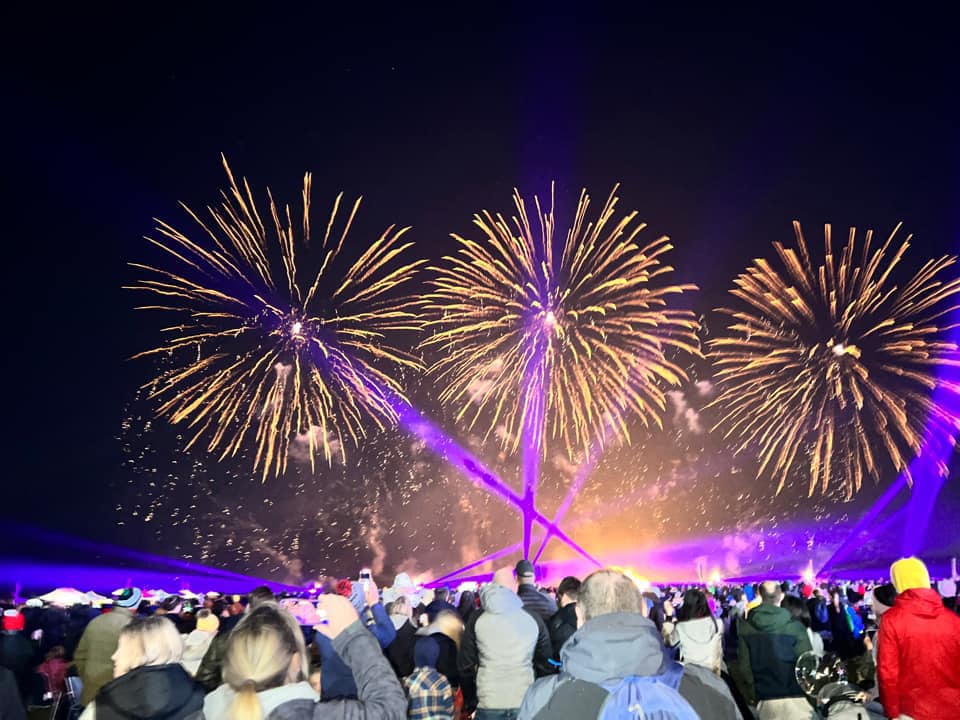 Vibrant colourful fireworks explosions filling the night sky