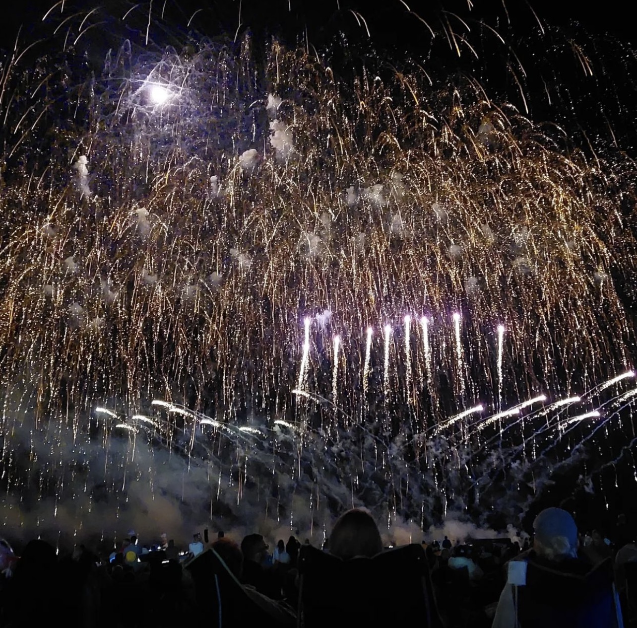 Close sparks and golden cascades filling the airfield sky